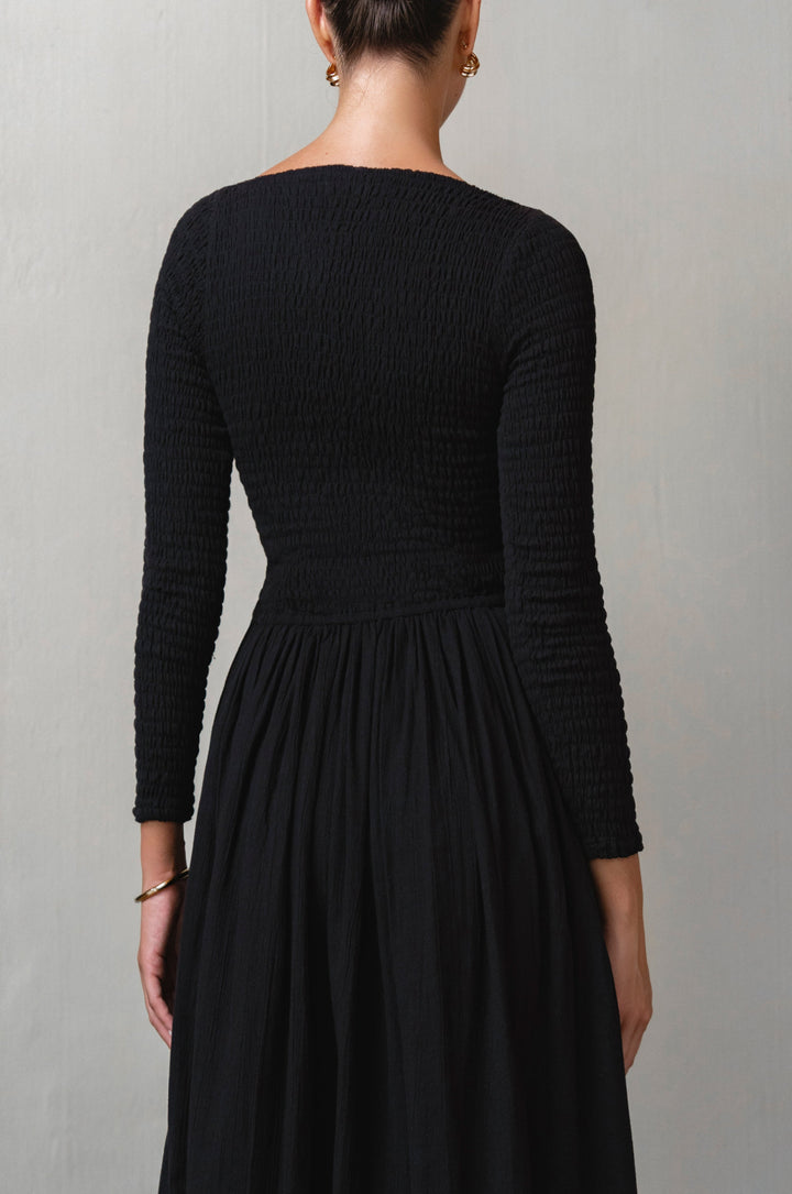 Black dress with long sleeves on a plain background