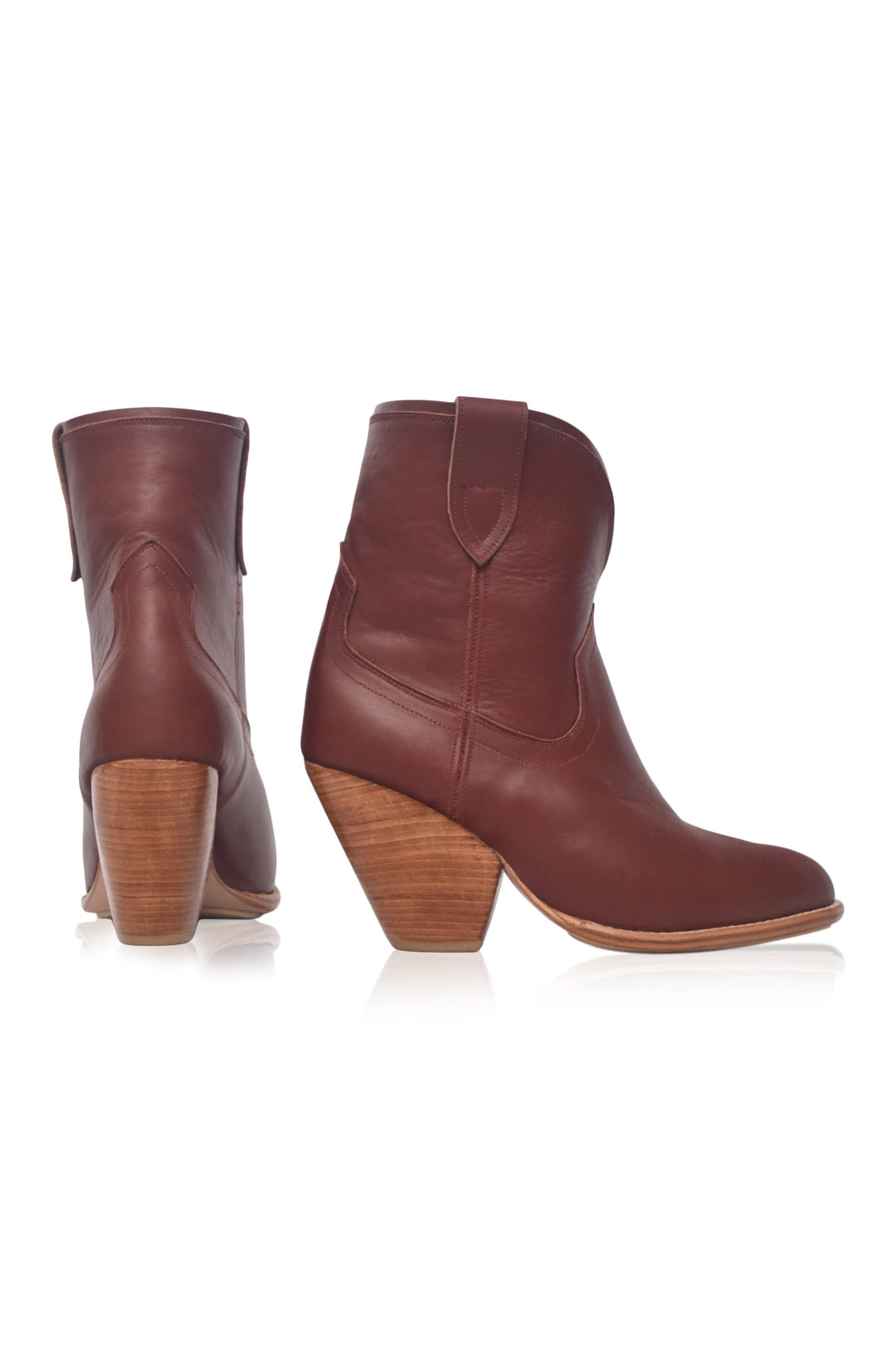 Pair of brown leather ankle boots with wooden soles on a white background
