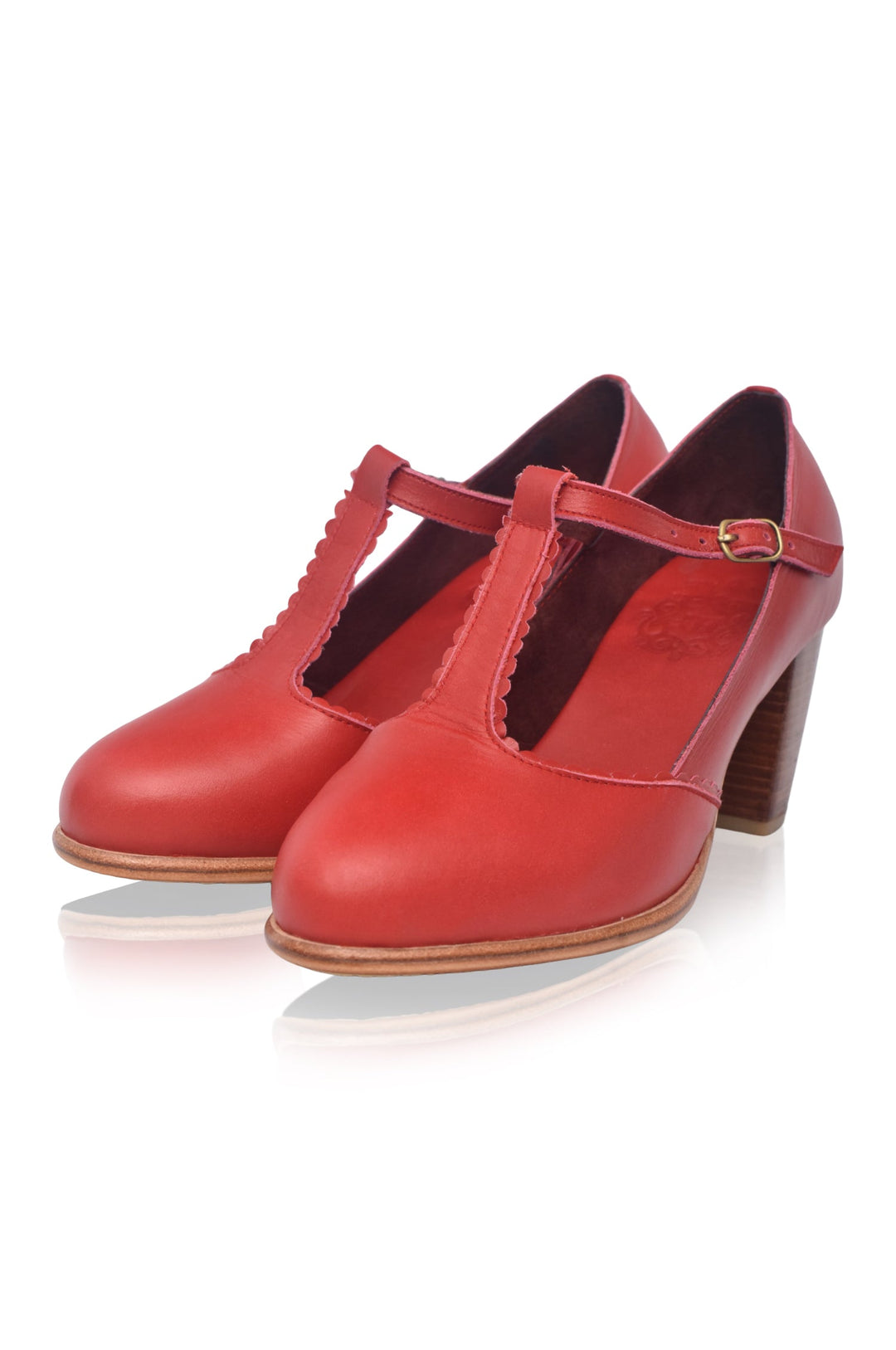 Red high-heeled shoes with a strap on a white background