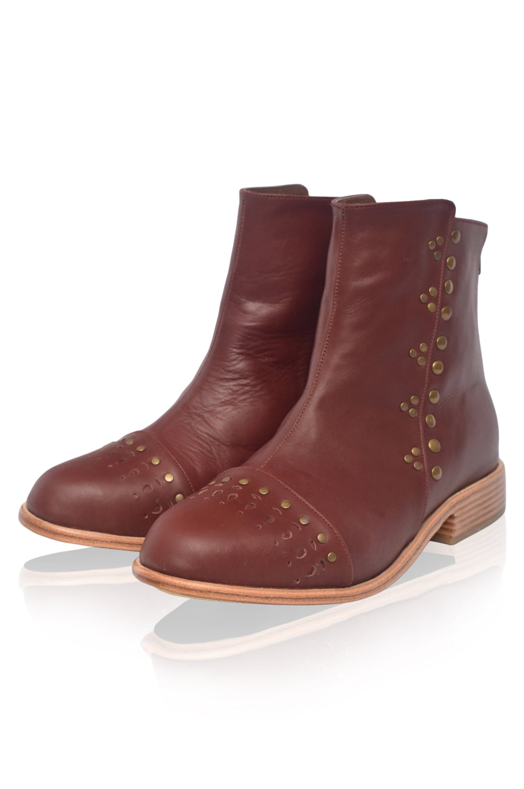 Pair of brown leather ankle boots with decorative studs on a white background