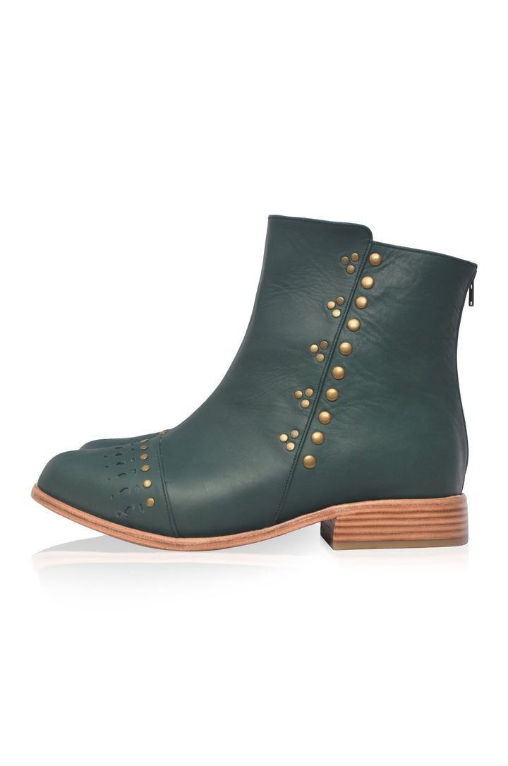 Green ankle boot with gold studs on a white background