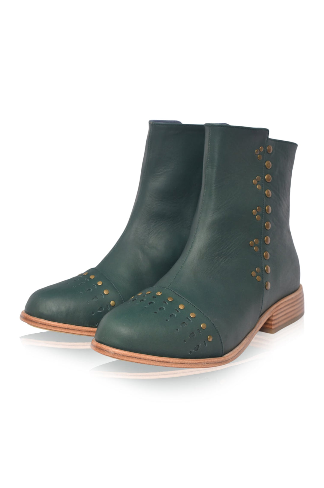 Pair of green ankle boots with brown soles on a white background