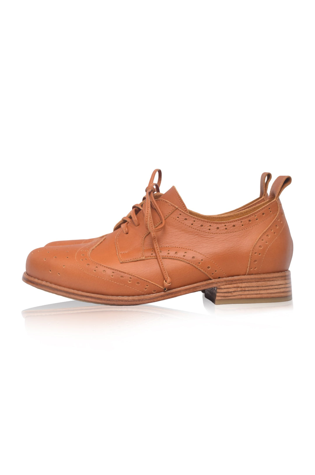 Brown leather brogue shoe on a white background