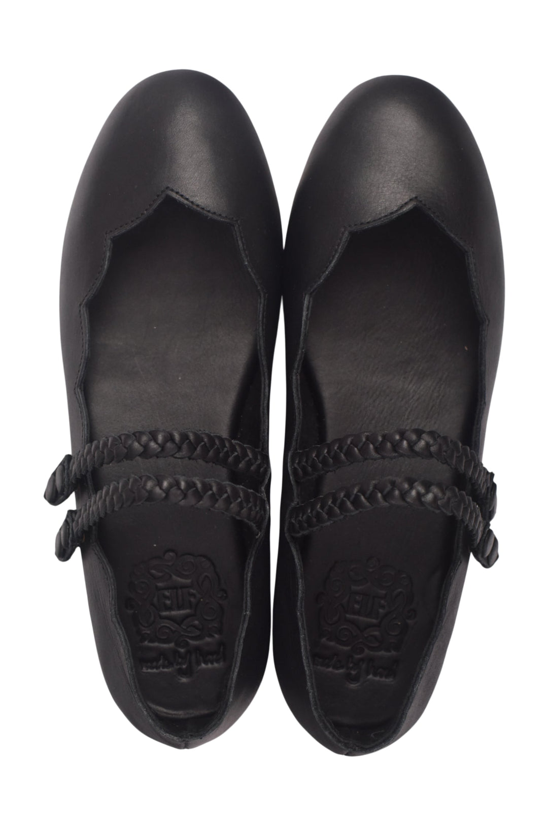 Pair of black shoes with braided details and scallops on a white background