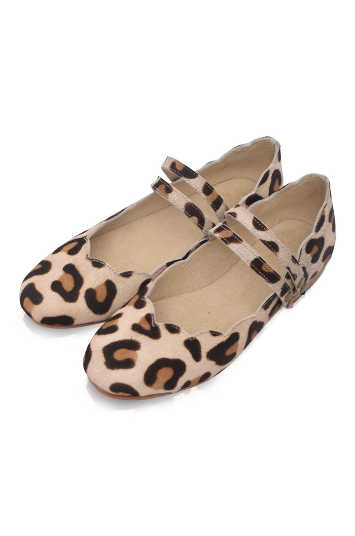 Pair of leopard print flats on a white background