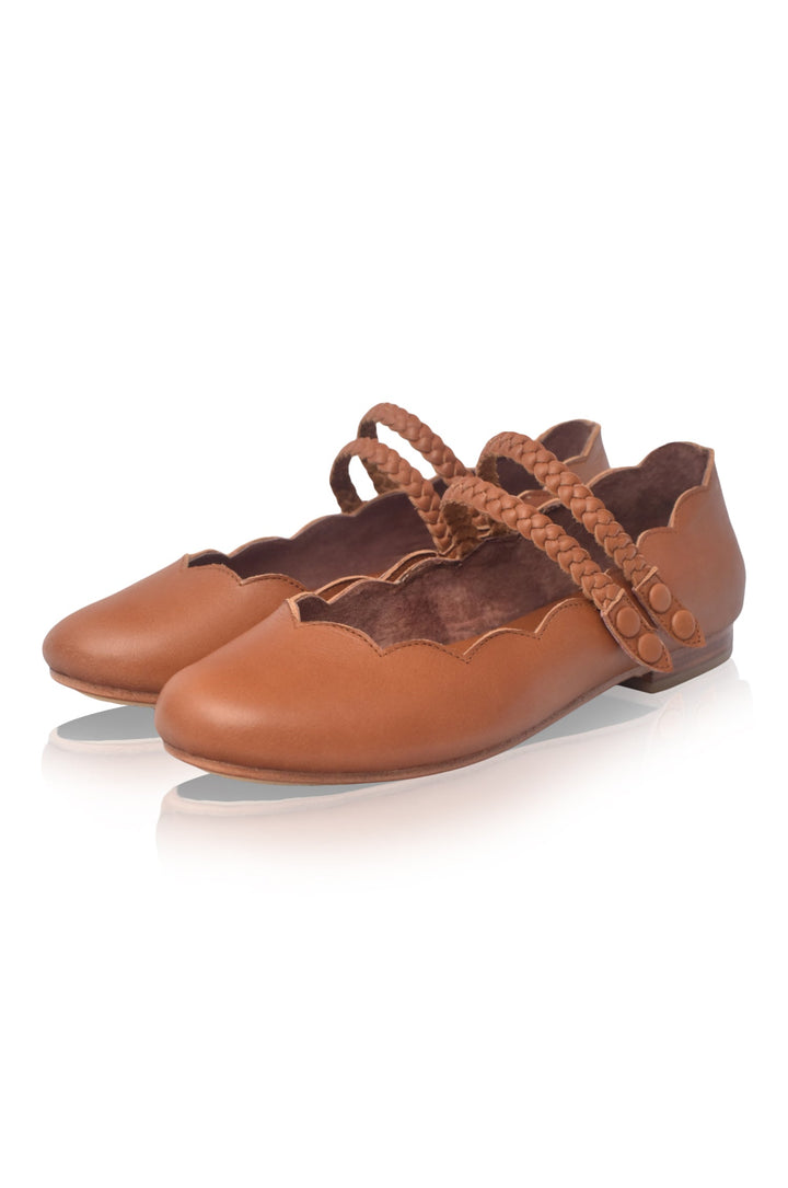 Pair of brown leather shoes with decorative straps 
