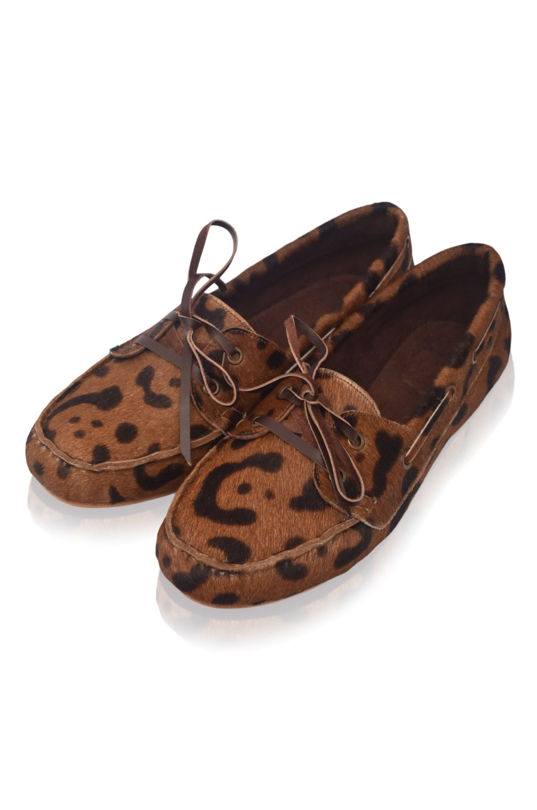 Pair of brown loafers with black leopard print pattern on a white background