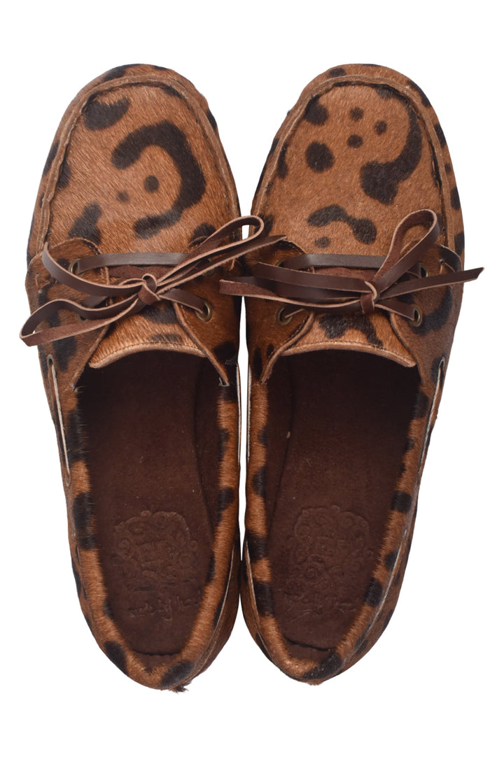 Pair of brown loafers with a leopard print pattern on a white background
