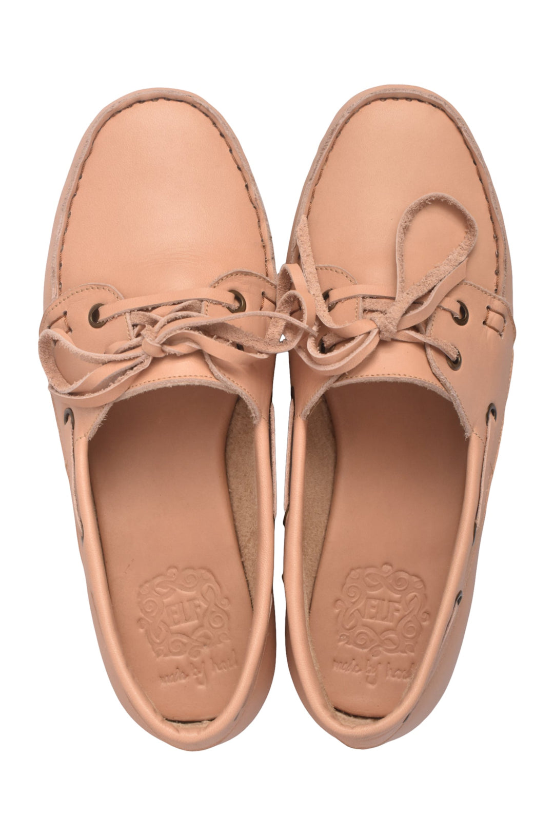 Pair of tan leather shoes with laces on a white background