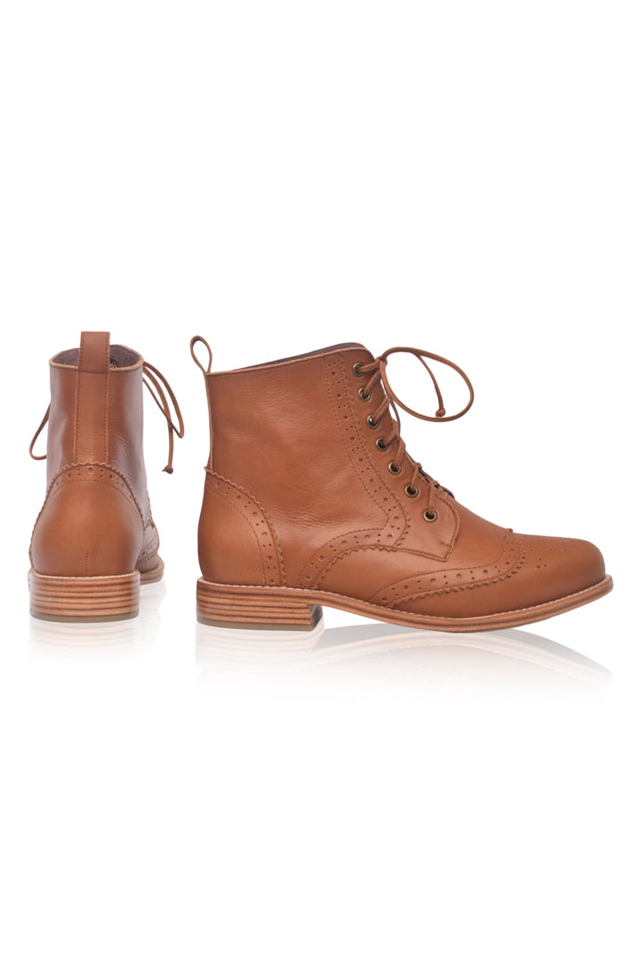 Pair of brown leather boots on a white background