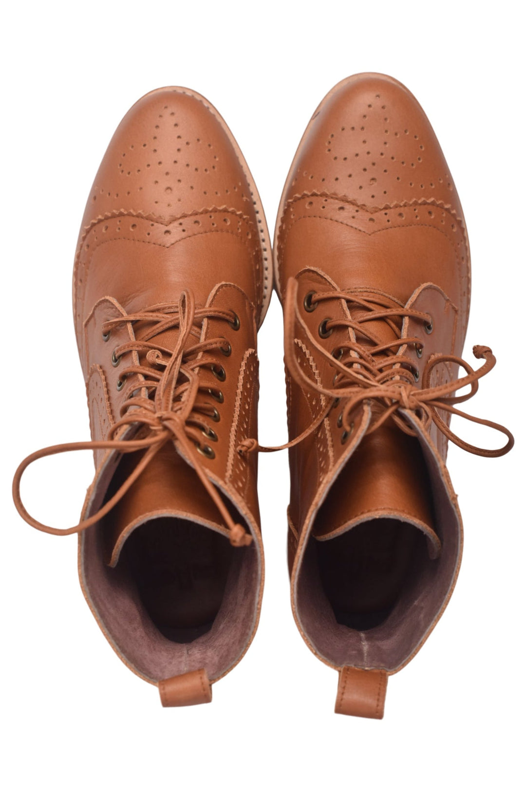 Pair of brown leather brogue shoes on a white background