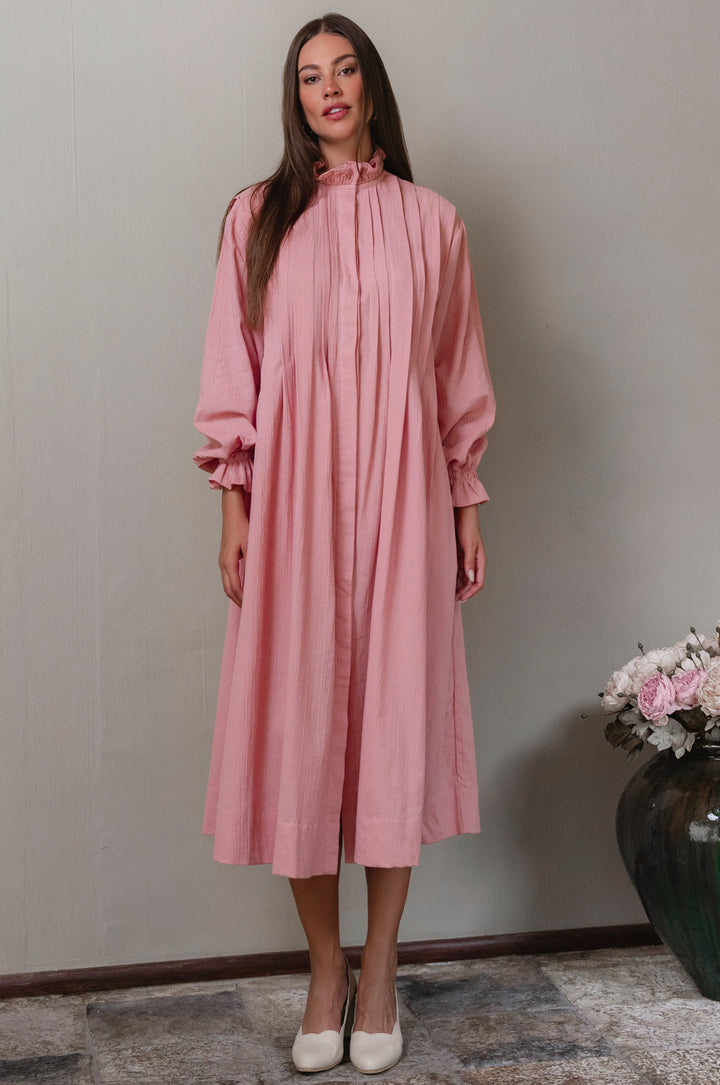 Woman wearing a pink long sleeve linen dress 