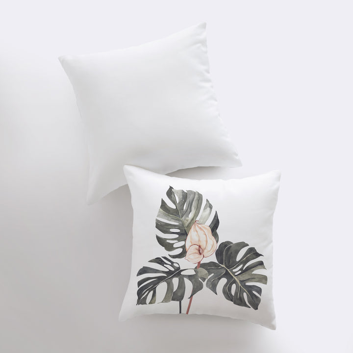 two white pillows with a pink flower on them